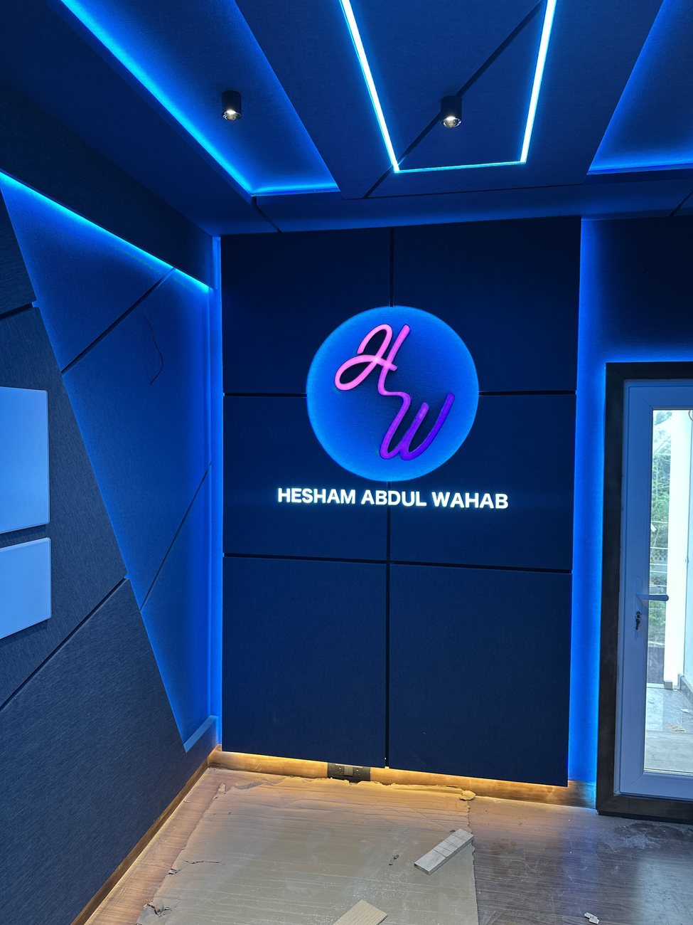 Hesham Abdul Wahab studio interior with blue LED ambience and illuminated logo